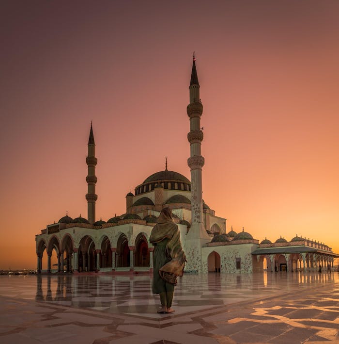 Beautiful evening view of the Sharjah Mosque with a mesmerizing pink sky and sunset.