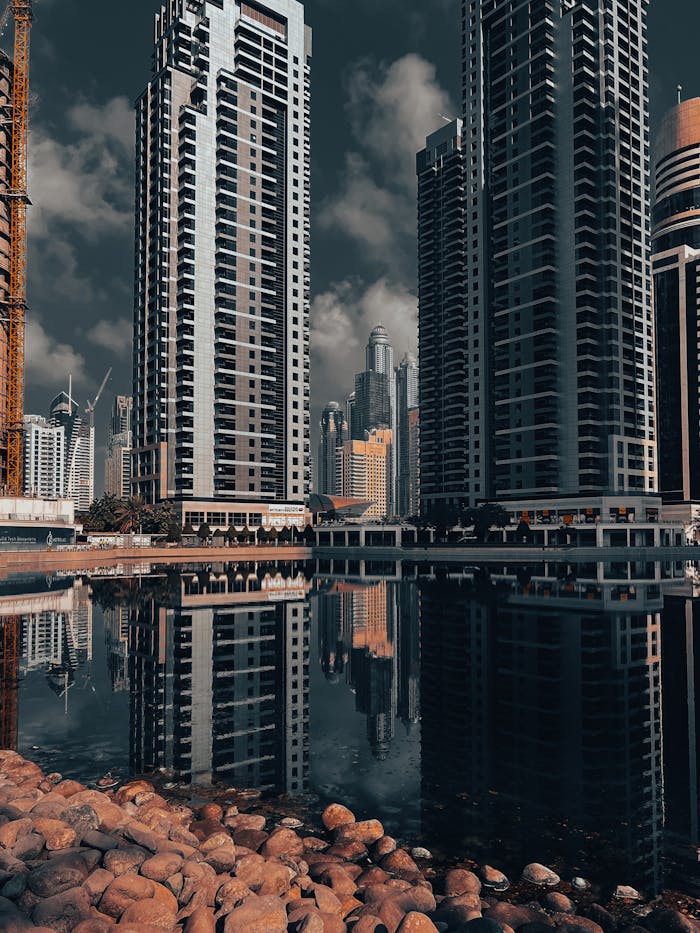 Captivating image of Dubai skyscrapers reflecting on water, creating an urban oasis feel.