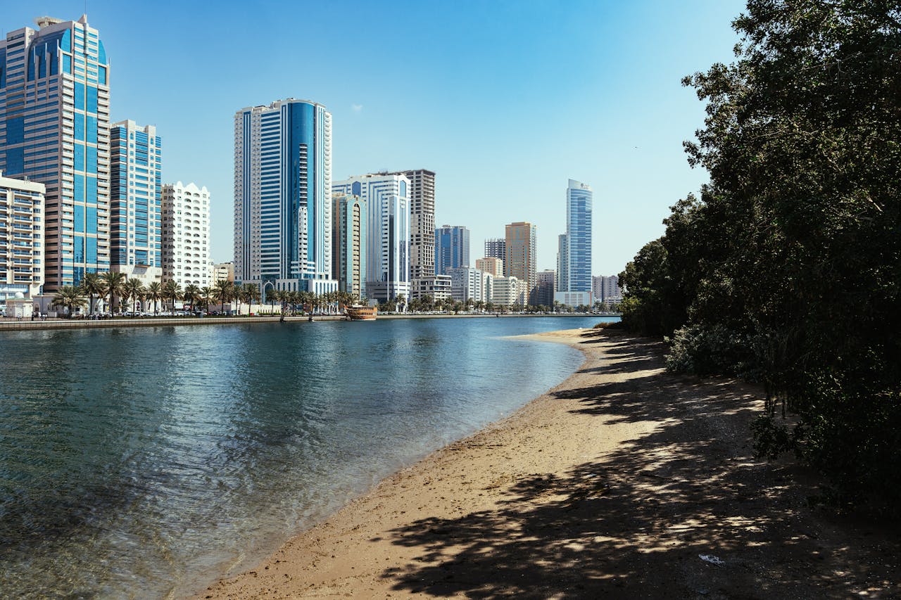 Stunning view of Sharjah's modern skyline along the Al Majaz waterfront, showcasing high-rise buildings.